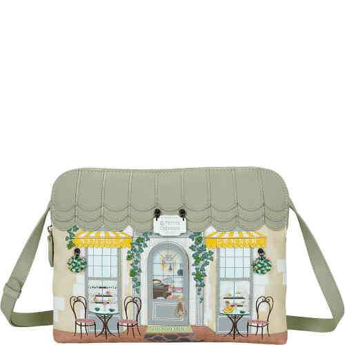 This is an east west crossbody bag, medium in size, that will fit an iPad in its case easily. , It is made from soft sage green and cream vegan leather, adorned with embroidered vines over a Parisian creperie. Vegan bag/accessory designed by Vendula London, available online and instore at ShoeBeDoo, official stockist in Australia