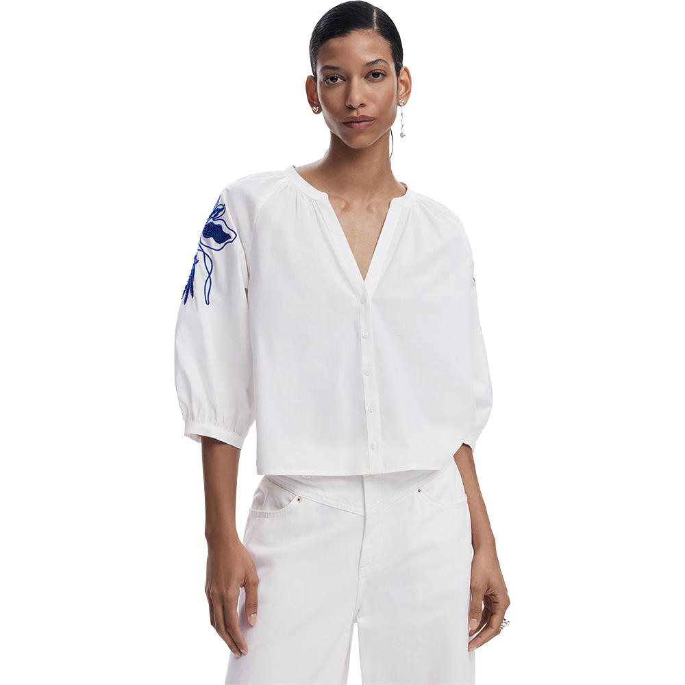 A pretty white peasant blouse with cobalt blue embroidery and sequins that are on the top of the right and the left sleeve side. ShoeBeDoo is an authorised and official stockist of Desigual in Australia and new Zealand.