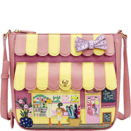A large roomy crossbody with pockets galore and a divine haberdashery of fabrics and sewing goodies on the front. It looks like shop front with a rhubarb pink and cream striped canopy on the front, and mannequins dressed by cats, wicker baskets full of fabric spools, and other charming details. ShoeBeDoo is an authorised stockist of Vendula London Certified Vegan bas and wallets in Australia and New Zealand
