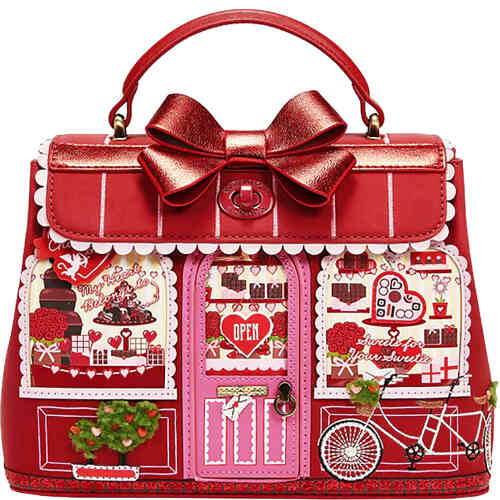 This shop front bag from Vendula depicts a stunning canopied top mid sized bag. with a lovely shiny red bow on the top. The front of the bag shows a chocolate store shop front with two glossy windows with chocolates and treats, and in the centre is a pink door that opens to reveal even more! ShoeBeDoo is an authorised stockist of Vendula London Certified Vegan Leather Bags and Accessories in Australia and New Zealand